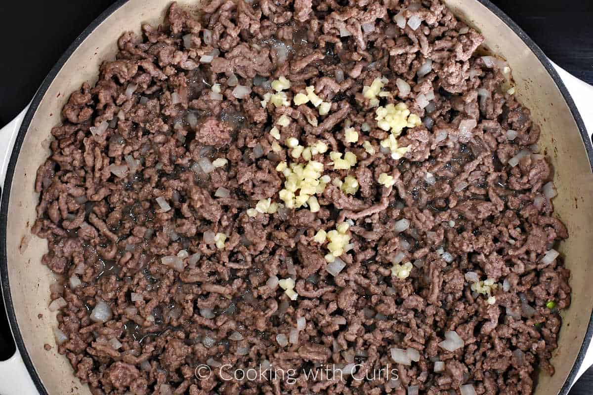 Minced-garlic-on-top-of-ground-beef-in-a-skillet.