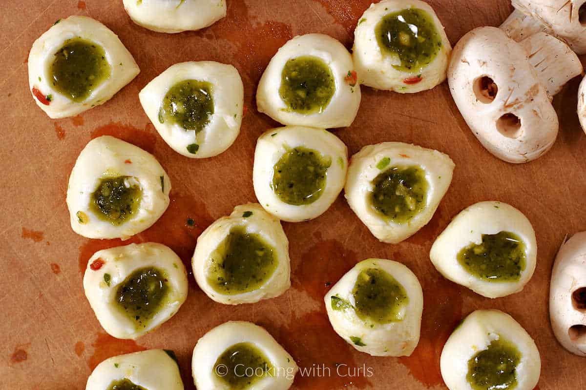 Mozzarella balls filled with pesto in the center.