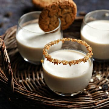 Three oatmeal cookie cocktails on a wicker tray.