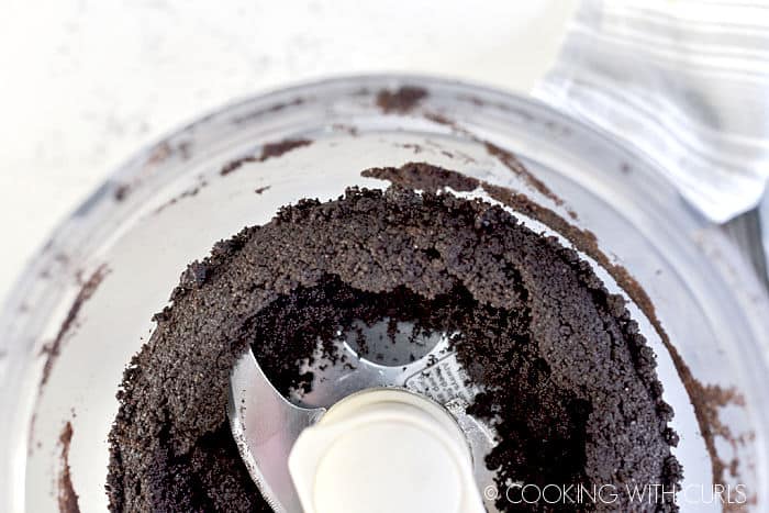 OREO cookies mixed with butter in a food processor. 