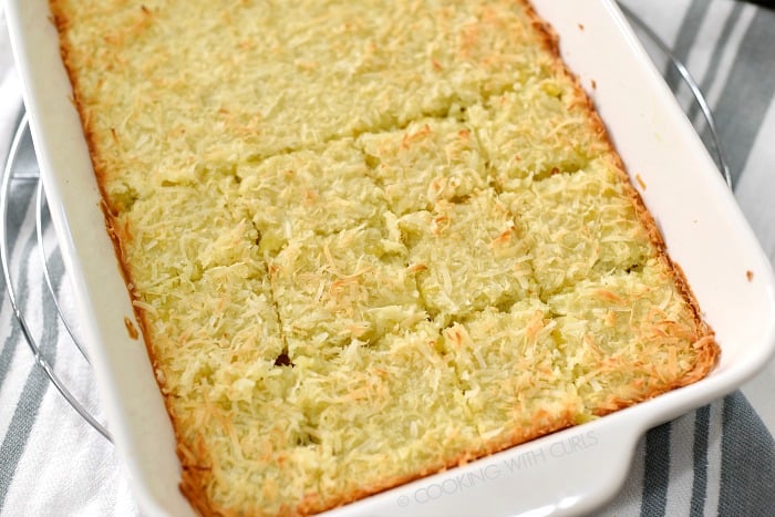 Pina Colada Bars cut into squares in a white baking dish.