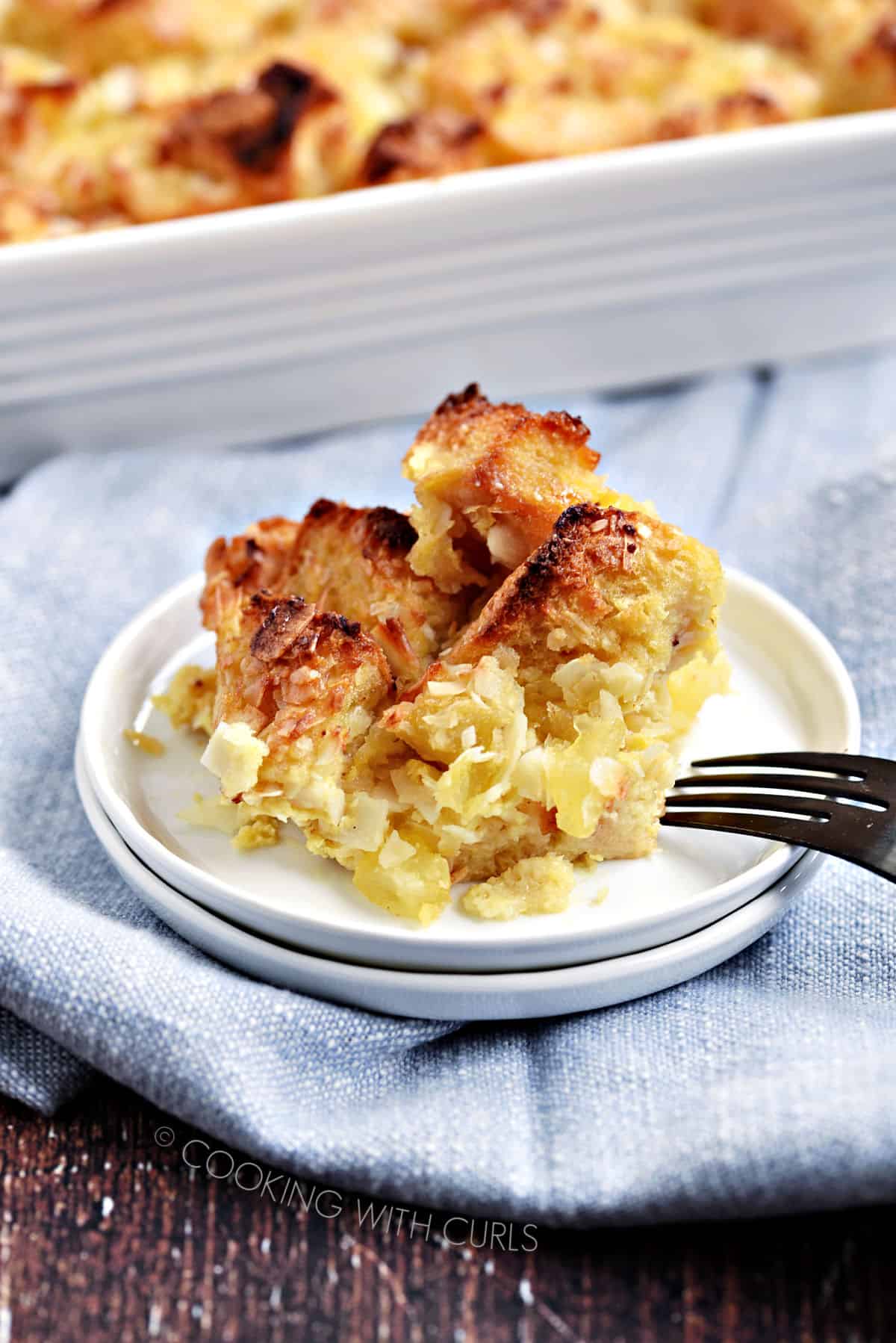 Pina Colada Bread Pudding served on a small white plate. 