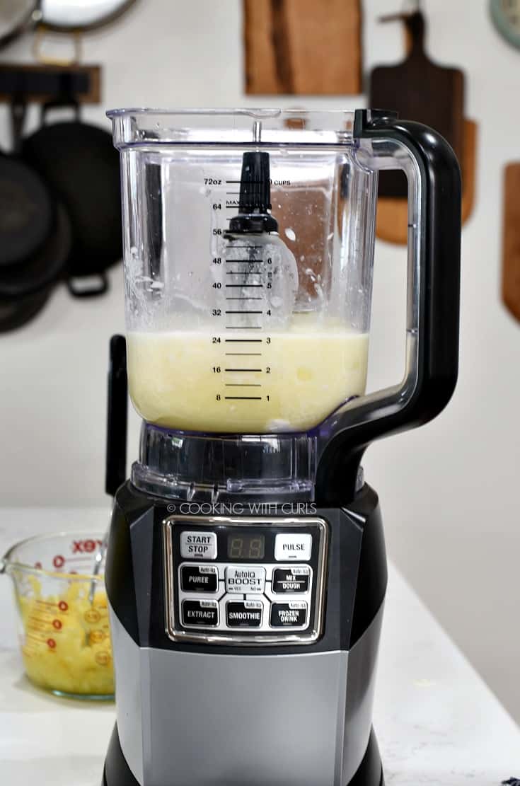 Pineapple juice, cream of coconut, cream and rum in a blender 