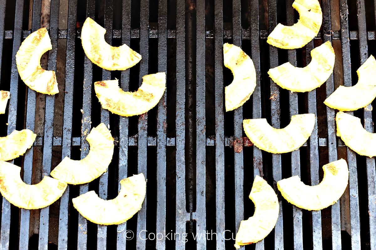 Pineapple slices on a gas grill. 