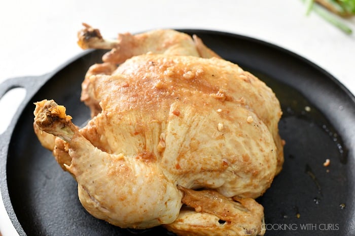 Place the cooked chicken on a cast iron skillet .
