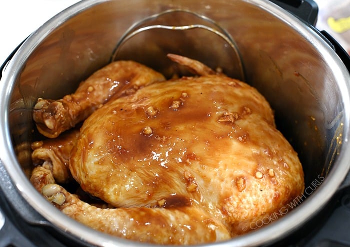 Pour the marinade over the chicken in the pressure cooker.