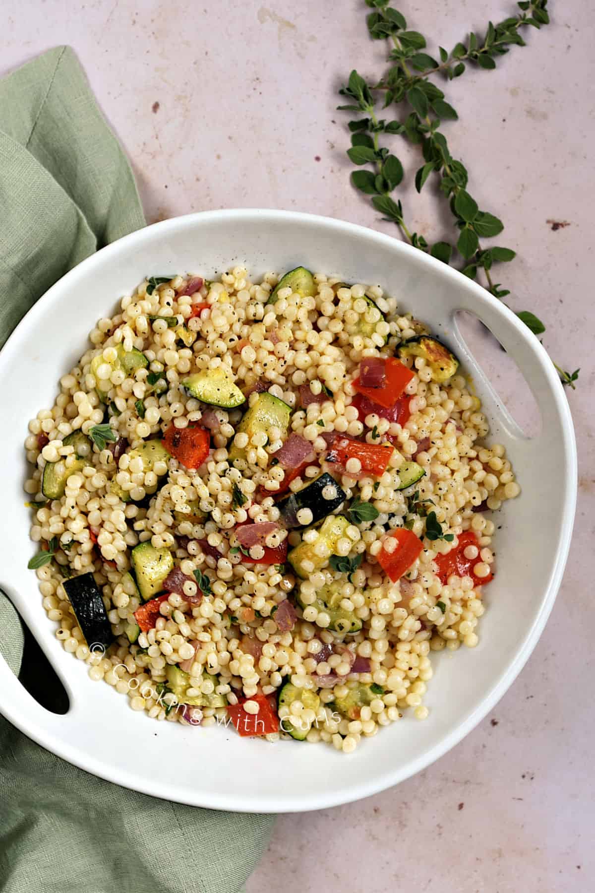 Looking down on a serving bowl filled withRoasted Vegetable Couscous. 