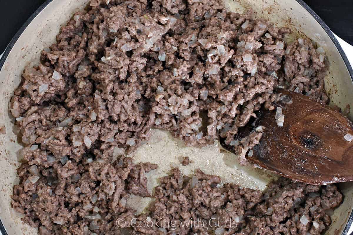 Roux-mixed-into-ground-beef-with-a-wood-turner-in-a-skillet.