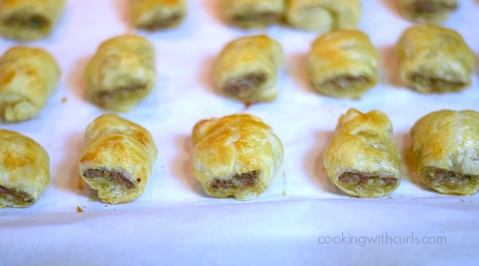 Fifteen baked Puff Pastry Sausage Rolls on a baking sheet.