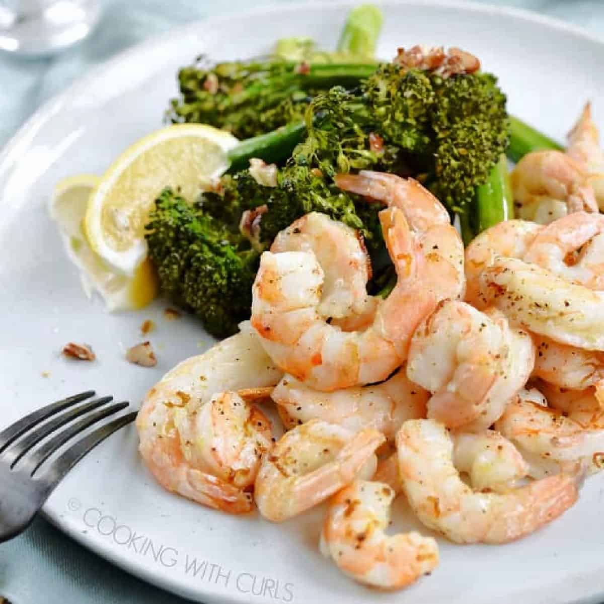 Oven roasted sheet pan shrimp and broccolini on a plate.