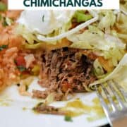 A shredded beef chimichanga cut open on a plate to show the filling topped with sour cream and shredded lettuce with title graphic across the top.