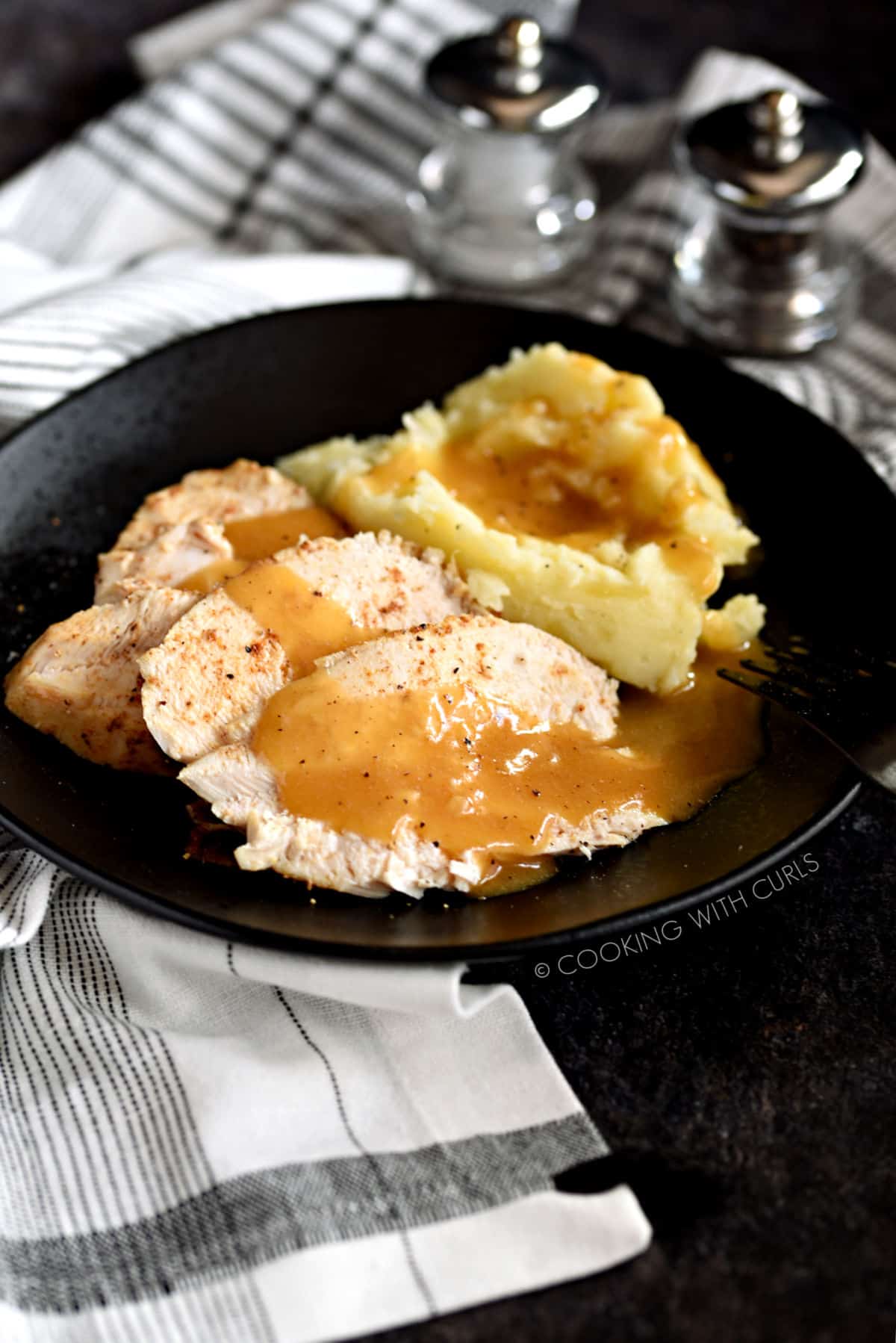 Sliced Faux-tisserie Chicken with mashed potatoes and gravy. 
