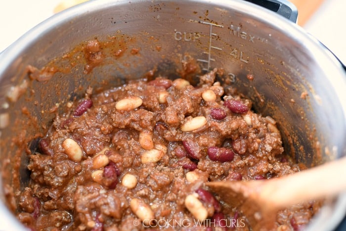 Stir in the crushed tomatoes and beans.