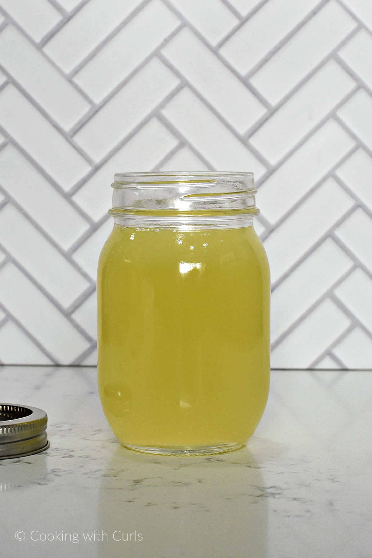 Sweet and sour mix recipe mixed together in a glass mason jar.