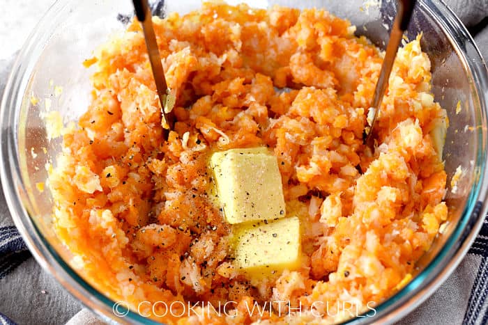 Three pats of butter, salt and pepper added to the mashed carrots and parsnips. 