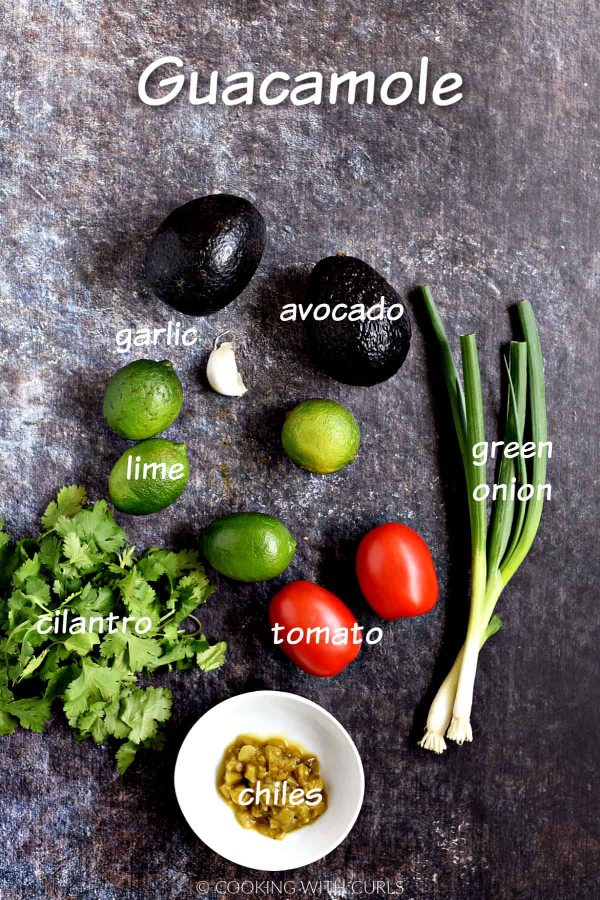 Two avocados, limes cilantro, garlic, green onions, tomatoes, and chiles. 