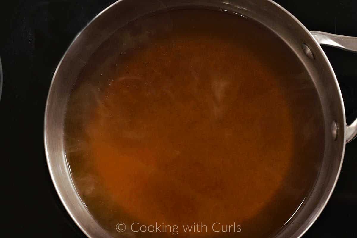Vegetable stock simmering in a saucepan. 