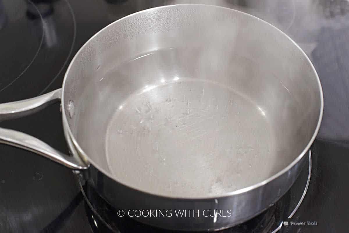 Simmering water in a saucepan.