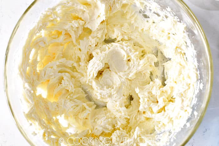 Whipped cream cheese and sugar in a glass bowl.