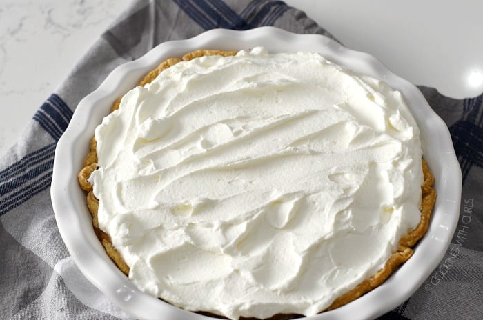 Whipped cream spread over the top of the pie 