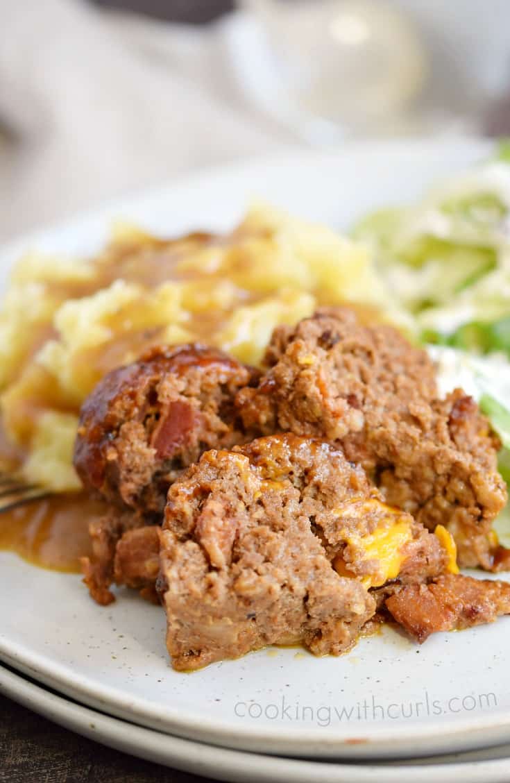 Cheeseburger Meatloaf served with mashed potatoes on a white plate.